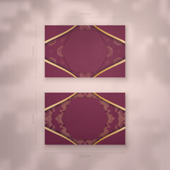A presentable burgundy business card with an antique gold pattern for your contacts.