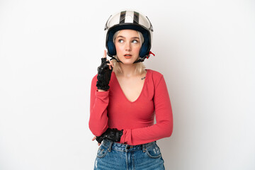 Young caucasian woman with a motorcycle helmet isolated on white background thinking an idea pointing the finger up