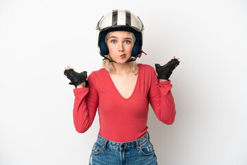 Young caucasian woman with a motorcycle helmet isolated on white background having doubts while raising hands