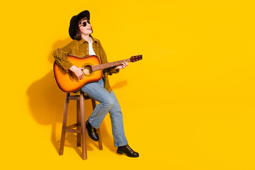 Photo of pretty charming lady wear cowgirl outfit glasses headwear playing guitar singing empty...