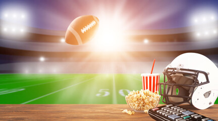 Food and drinks on a wooden table . TV broadcast of American football background. Sport bar concept