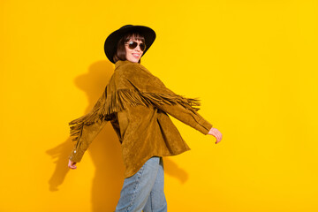Profile side view portrait of attractive cheery girl cowboy dancing isolated over bright yellow...