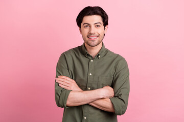 Fototapeta premium Photo of young happy positive confident man hands crossed good mood smile isolated on pastel pink color background