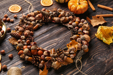 Fototapeta premium Beautiful acorn wreath on dark wooden background