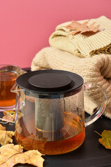 Tea pot on table near pink wall