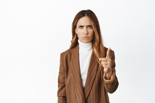 Angry And Displeased Lady Boss Shaking Finger, Frowning And Sulking Disappointed, Scolding Employee, Being Strict, Standing Over White Background