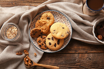 Plate with tasty homemade cookies on wooden background
