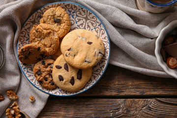 Plate with tasty homemade cookies on wooden background