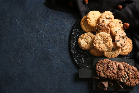 Boards with tasty homemade cookies on black background