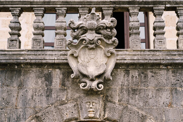 Balustrade of an old building with a coat of arms. Perast, Montenegro