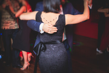 Couples dancing traditional latin argentinian dance milonga in the ballroom, tango salsa bachata...