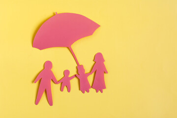Minimalistic painting of a family under the protection of a large umbrella on a bright yellow background of flats