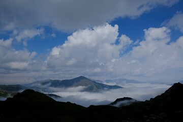 Beautiful mountain view above clouds during hiking on peak Djeravica (Gjerovica) - the highest peak of Kosovo. Albanian Alps, Peaks of Balkans