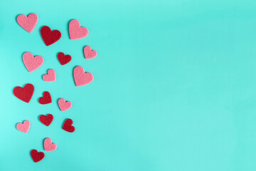 Light blue bright background with colorful hearts of red and pink colors	