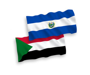 National vector fabric wave flags of Republic of El Salvador and Sudan isolated on white background. 1 to 2 proportion.