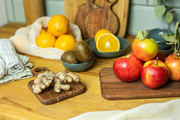 Auswahl an Obst auf Frettchen, in verschiedenen Schalen und Tellern auf Holzuntergrund mit Fliesenspiegel. Gesunde, vitaminreiche, vegane Ernährung, ethisch nachhaltiger Lebensstil, umweltfreundlich, 