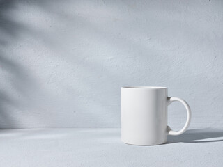 Obraz na płótnie Canvas White cup on gray background