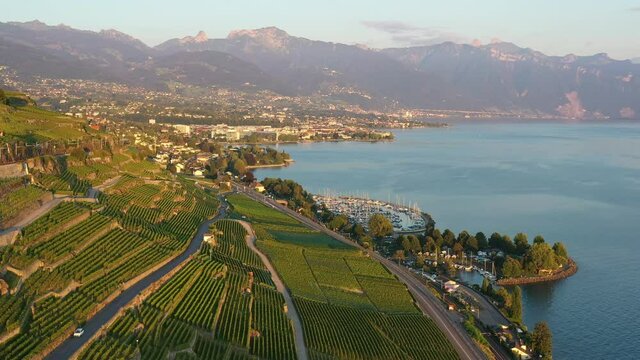 Aerial drone footage of the Lavaux famous terrace vineyard by lake Geneva between Montreux and Lausanne in Switzerland. 