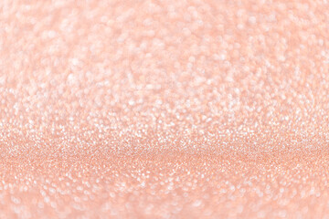 Abstract blurred coral or peach magic glitter background with copy space.