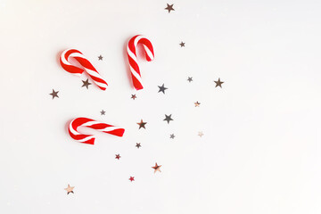 Christmas candies.New Year gifts.Christmas and New Year background. Bright Winter holiday composition.Christmas composition. Gifts, spruce branches, red decorations on a white background.