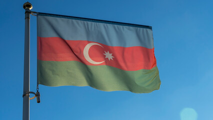 Azerbaijan flag waving on the wind in front of sun. Diplomacy concept. International relations.