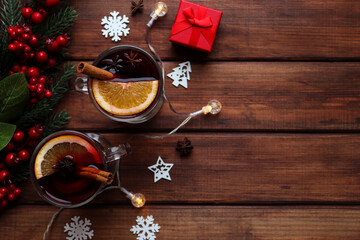 Two glasses of mulled wine on a festive table decorated for Christmas with copy space. Christmas hot drinks. Top view, selective focus