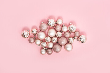 Decorative pink balls on a pink background. Top view, flat lay.