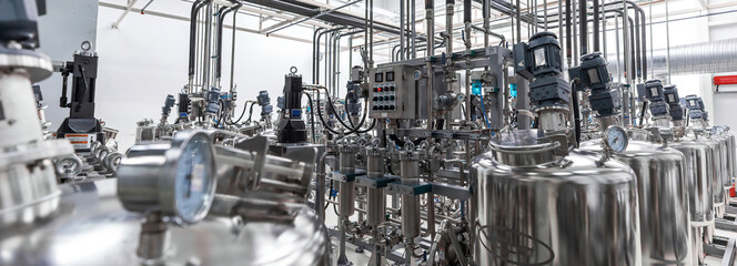 Panoramic photo of pipes and tanks. Chemistry and medicine production. Pharmaceutical factory....