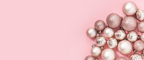 Decorative pink balls on a pink background. Top view, flat lay. Banner.