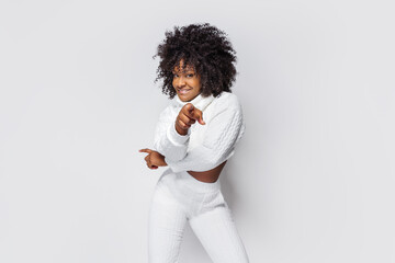 Waist-up shot of attractive african-american curly-haired woman having fun, dancing enjoying christmas party, raise hands up and smiling enjoying own body, move to rhythm, white background