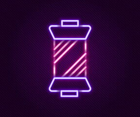Glowing neon line Sewing thread on spool icon isolated on black background. Yarn spool. Thread bobbin. Colorful outline concept. Vector