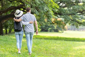 Couple people lover outdoor walking embrace together at park green space for text
