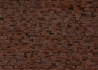 A dark red wall made of old bricks. Brick texture made of uneven elements. Dark background.