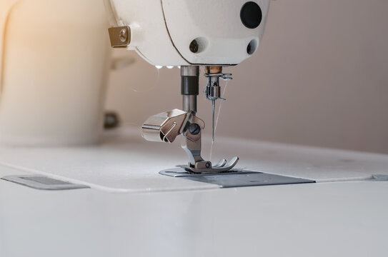 Sewing machine. Sewing machine needle..Foot sewing machine with thread inserted on the needle.