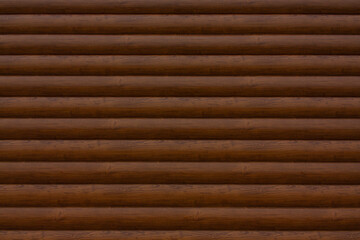 The wall is made of horizontal wooden beams of brown color. Wooden texture. Brown background.