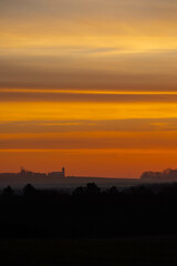 Colorful Wisconsin sunset with silhouette of farm in November