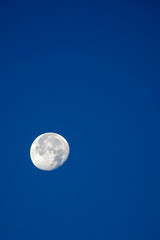 Moon in the waning gibbous phase with blu sky in October