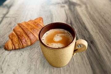 Fresh baked breakfast croissants with cup hot espresso coffee
