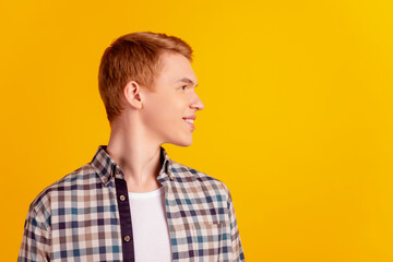 Profile side photo of young cheerful man good mood look empty space isolated over yellow color background