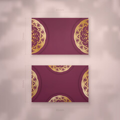 Burgundy business card template with Greek gold ornaments for your personality.