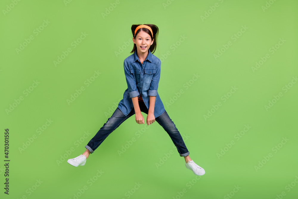 Sticker Photo of cute funny student girl wear denim shirt smiling jumping high riding horse isolated green color background