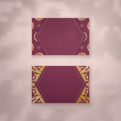 Burgundy business card template with Greek gold pattern for your brand.