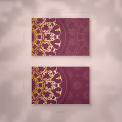 Burgundy business card template with Greek gold pattern for your brand.
