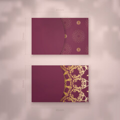 Burgundy business card template with Greek gold pattern for your contacts.