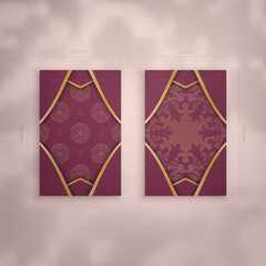 Burgundy business card template with Indian gold pattern for your brand.