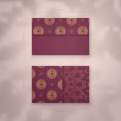 Burgundy business card template with Indian gold pattern for your contacts.