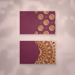 Burgundy business card template with luxurious gold ornaments for your personality.