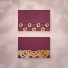 Burgundy business card template with luxurious gold pattern for your brand.