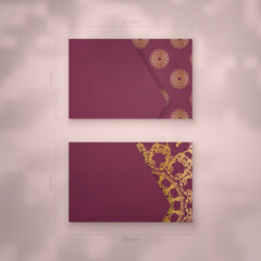 Burgundy business card template with mandala gold ornament for your brand.