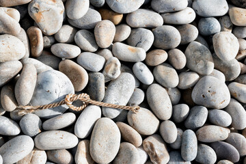 Rope knot on pebble beach